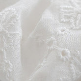 Close-up of off-white embroidered lace scrunchie – Avauma